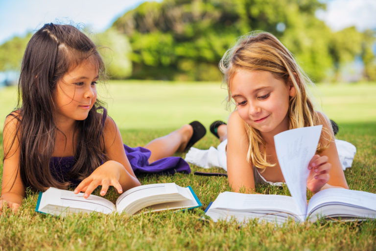 Cute Little Girls Reading Books Outside, Friendship and Learning Concept